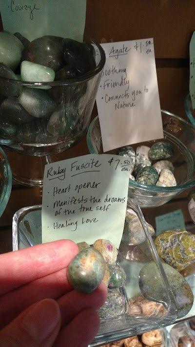 Variety of gemstones, crystal carvings, and polished mineral specimens