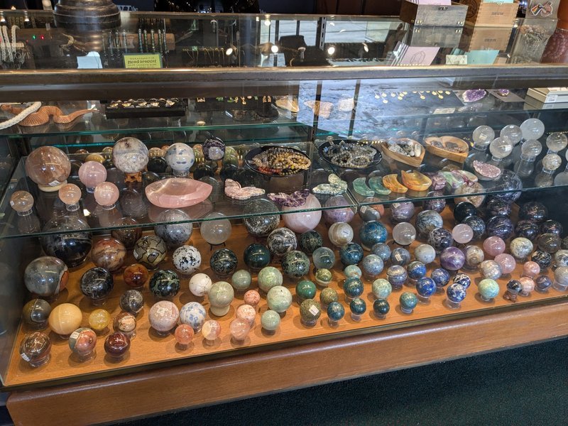Display of polished crystal specimens, geodes, and mineral towers