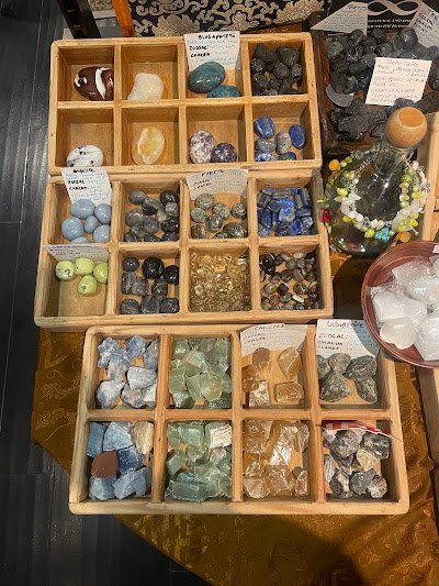 Shelving display featuring amethyst, quartz, and various crystal specimens