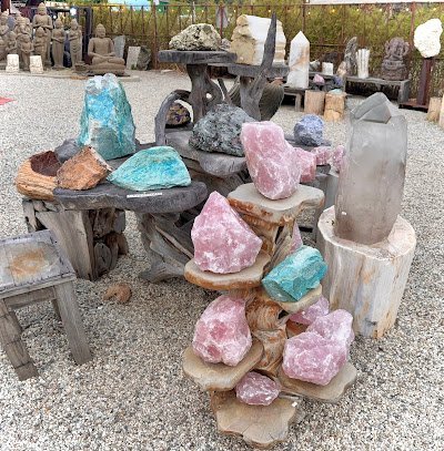 Shelving display featuring amethyst, quartz, and various crystal specimens