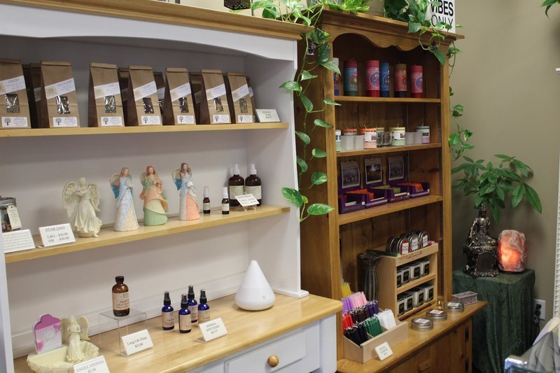 Display featuring crystal points, polished stones, and raw mineral specimens