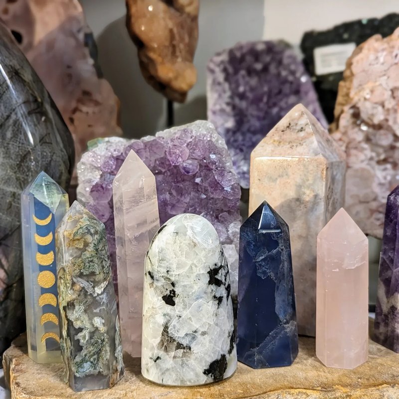 Display featuring crystal points, polished stones, and raw mineral specimens
