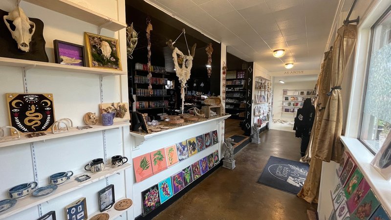 Retail space with metaphysical supplies, tarot cards, and spiritual decor
