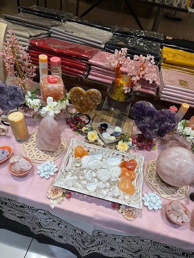 Display featuring crystal points, polished stones, and raw mineral specimens